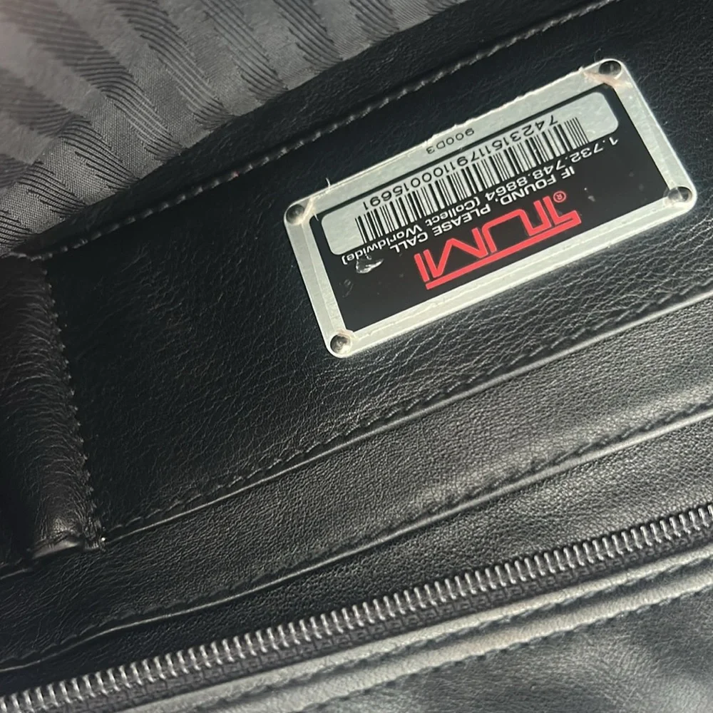 Tumi black leather bag